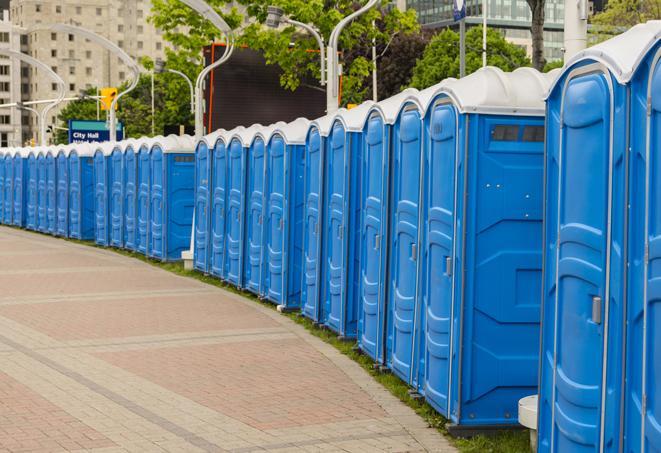 a line of portable restrooms at a sporting event, providing athletes and spectators with clean and accessible facilities in Blair